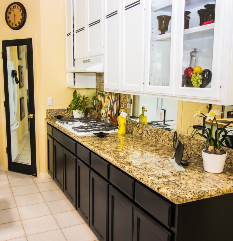 3 Kitchen with black cabinets, granite countertops, and white appliances
