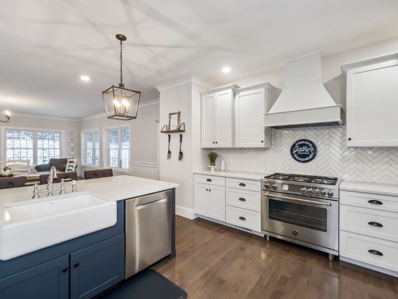 4 Kitchen with white cabinets, stainless steel appliances, and a blue island