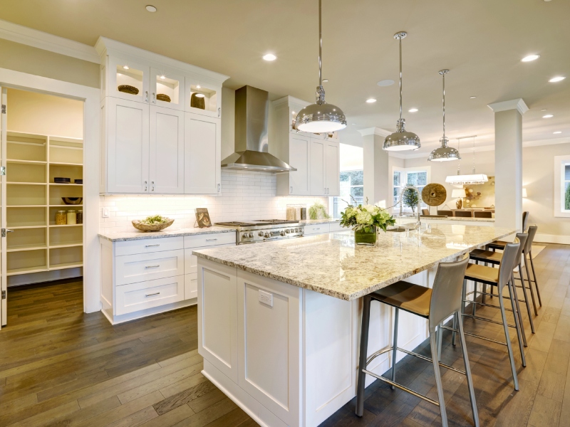 Kitchen with pendant lights, a double sink, and a tiled floor