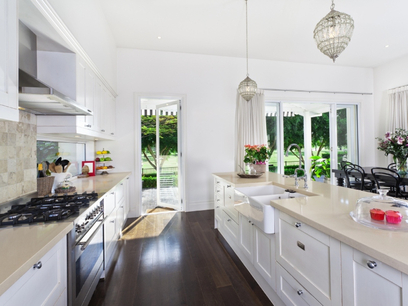 Bright and airy kitchen with natural light, a cozy dining nook, and a welcoming island
