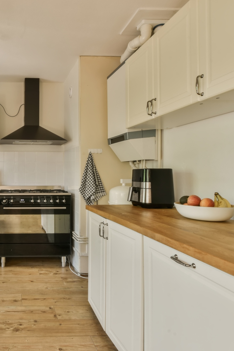9 Spacious kitchen with white cabinets, a stainless steel microwave and oven, and a black stovetop
